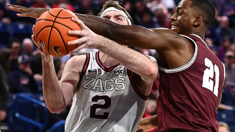 Dec 20, 2022; Spokane, Washington, USA; Gonzaga Bulldogs forward Drew Timme (2) is fouled by Montana Grizzlies forward Laolu Oke (21) in the second half at McCarthey Athletic Center. Gonzaga won 85-75. Mandatory Credit: James Snook-USA TODAY Sports
