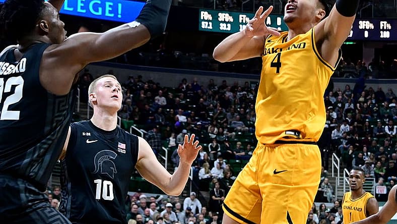 Dec 21, 2022; East Lansing, Michigan, USA;  Oakland Golden Grizzlies forward Trey Townsend (4) looks for a shot past Michigan State Spartans center Mady Sissoko (22) at Jack Breslin Student Events Center. Mandatory Credit: Dale Young-USA TODAY Sports