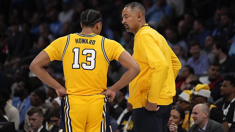 Dec 21, 2022; Charlotte, North Carolina, USA; Michigan Wolverines head coach Juwan Howard talks with guard Jett Howard (13) during the first half against the North Carolina Tar Heels at the Jumpman Classic at the Spectrum Center. Mandatory Credit: Jim Dedmon-USA TODAY Sports