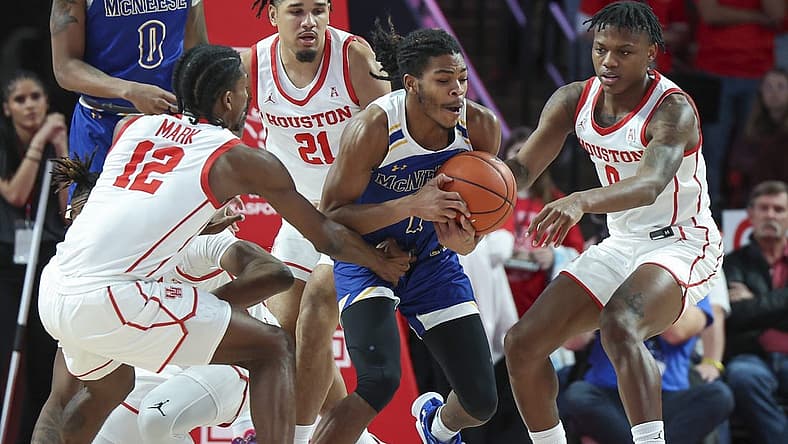 Dec 21, 2022; Houston, Texas, USA; McNeese State Cowboys guard Trae English (1) gets control of a loose ball away from Houston Cougars guard Tramon Mark (12) and guard Marcus Sasser (0) during the first half at Fertitta Center. Mandatory Credit: Troy Taormina-USA TODAY Sports