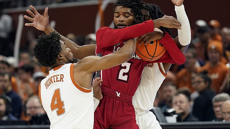Dec 21, 2022; Austin, Texas, USA; Louisiana-Lafayette Ragin' Cajuns guard Michael Thomas (2) tries to keep the ball away from Texas Longhorns guards Tyrese Hunter (4) and Marcus Carr (5) during the first half at Moody Center. Mandatory Credit: Scott Wachter-USA TODAY Sports