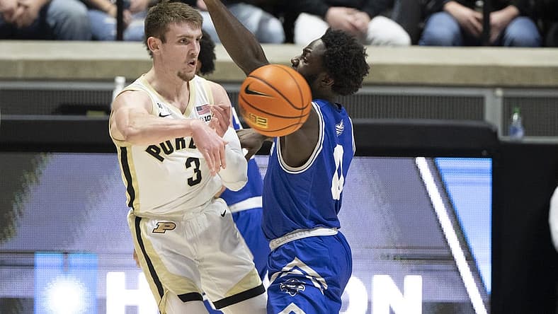 Dec 21, 2022; West Lafayette, Indiana, USA; Purdue Boilermakers guard Braden Smith (3) passes the ball around New Orleans Privateers guard Daniel Sackey (0) during the first half at Mackey Arena. Mandatory Credit: Marc Lebryk-USA TODAY Sports