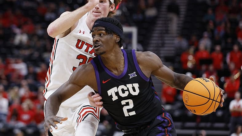 Dec 21, 2022; Salt Lake City, Utah, USA; TCU Horned Frogs forward Emanuel Miller (2) drives against Utah Utes center Branden Carlson (35) in the first half at Vivint Arena. Mandatory Credit: Jeffrey Swinger-USA TODAY Sports