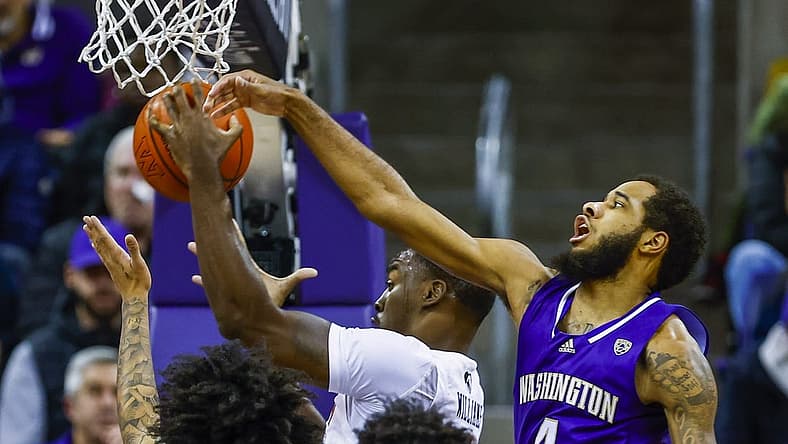 Dec 21, 2022; Seattle, Washington, USA; Auburn Tigers forward Jaylin Williams (2) collects an offensive rebound against Washington Huskies guard PJ Fuller II (4) during the first half at Alaska Airlines Arena at Hec Edmundson Pavilion. Mandatory Credit: Joe Nicholson-USA TODAY Sports