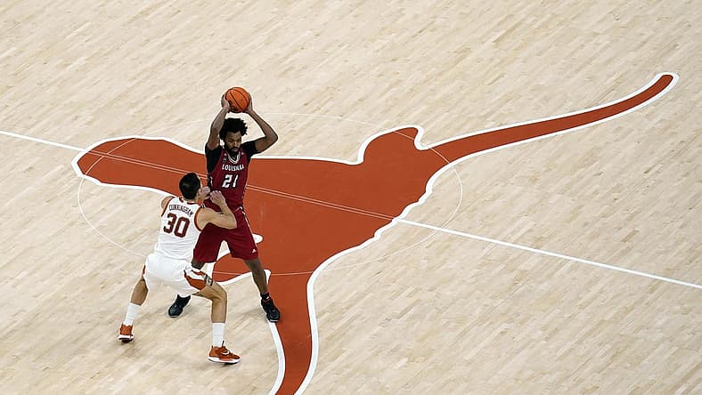 Dec 21, 2022; Austin, Texas, USA; Louisiana-Lafayette Ragin' Cajuns forward Jordan Brown (21) looks to pass the ball while defended by Texas Longhorns forward Brock Cunningham (30) during the second half at Moody Center. Mandatory Credit: Scott Wachter-USA TODAY Sports