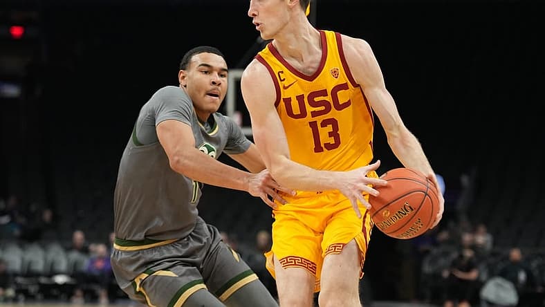 Dec 21, 2022; Phoenix, Arizona, USA; USC Trojans guard Drew Peterson (13) dribbles against Colorado State Rams guard John Tonje (1) during the first half at Footprint Center. Mandatory Credit: Joe Camporeale-USA TODAY Sports