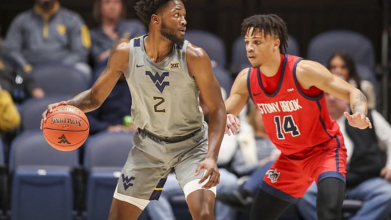 Dec 22, 2022; Morgantown, West Virginia, USA; West Virginia Mountaineers guard Kobe Johnson (2) dribbles against Stony Brook Seawolves guard Tyler Stephenson-Moore (14) during the first half at WVU Coliseum. Mandatory Credit: Ben Queen-USA TODAY Sports