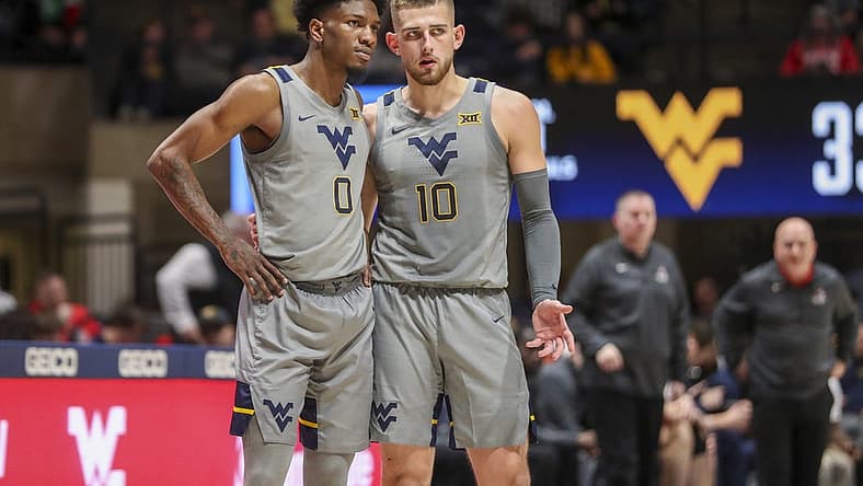 Dec 22, 2022; Morgantown, West Virginia, USA; West Virginia Mountaineers guard Erik Stevenson (10) talks with West Virginia Mountaineers guard Kedrian Johnson (0) during the second half against the Stony Brook Seawolves at WVU Coliseum. Mandatory Credit: Ben Queen-USA TODAY Sports
