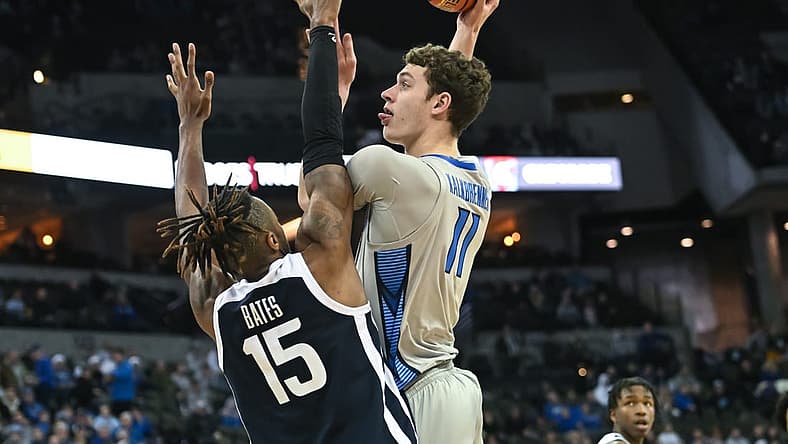 Dec 22, 2022; Omaha, Nebraska, USA; Creighton Bluejays center Ryan Kalkbrenner (11) scores over Butler Bulldogs center Manny Bates (15) in the second half at CHI Health Center Omaha. Mandatory Credit: Steven Branscombe-USA TODAY Sports