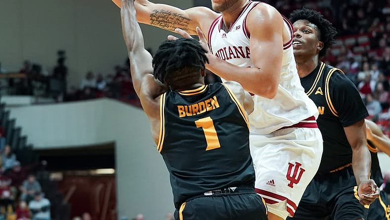 Dec 23, 2022; Bloomington, Indiana, USA; Indiana Hoosiers forward Race Thompson (25) passes the ball around Kennesaw State Owls guard Terrell Burden (1) during the first half at Simon Skjodt Assembly Hall. Mandatory Credit: Robert Goddin-USA TODAY Sports