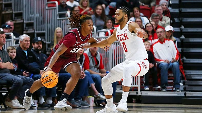 Dec 27, 2022; Lubbock, Texas, USA; South Carolina State Bulldogs forward Davion Everett (55) dribbles the ball against Texas Tech Red Raiders forward Kevin Obanor (0) in the first half at United Supermarkets Arena. Mandatory Credit: Michael C. Johnson-USA TODAY Sports