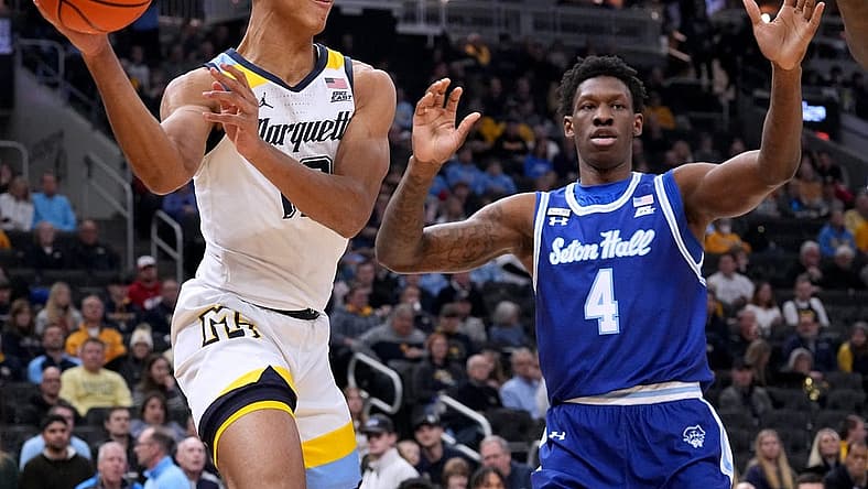 Dec 27, 2022; Milwaukee, Wisconsin, USA; Marquette forward Oso Ighodaro (13) finds an open man as Seton Hall forward Tyrese Samuel (4) defends during the first half at Fiserv Forum. Mandatory Credit: Mark Hoffman-USA TODAY Sports
