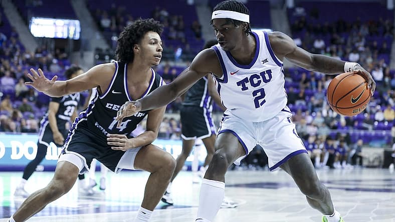 Dec 28, 2022; Fort Worth, Texas, USA; TCU Horned Frogs forward Emanuel Miller (2) controls the ball as Central Arkansas Bears guard Collin Cooper (14) defends during the first half at Ed and Rae Schollmaier Arena. Mandatory Credit: Kevin Jairaj-USA TODAY Sports