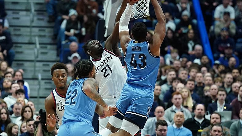 Dec 28, 2022; Hartford, Connecticut, USA; Connecticut Huskies forward Adama Sanogo (21) defends against Villanova Wildcats forward Eric Dixon (43) during the first half at XL Center. Mandatory Credit: David Butler II-USA TODAY Sports