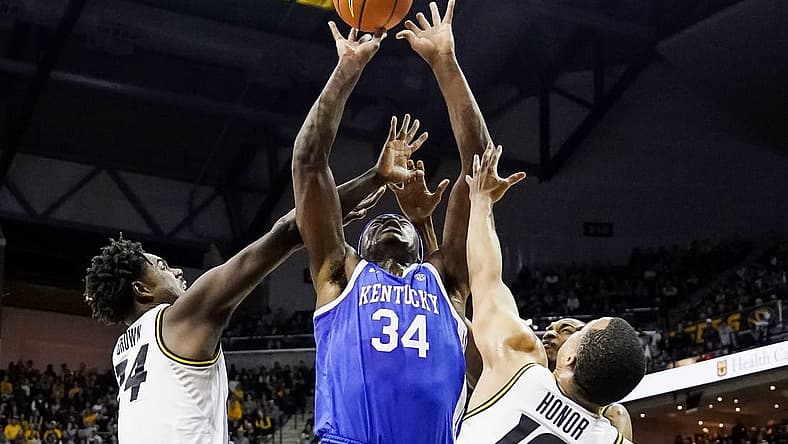 Dec 28, 2022; Columbia, Missouri, USA; Kentucky Wildcats forward Oscar Tshiebwe (34) goes up for a shot against Missouri Tigers guard Kobe Brown (24) and guard Nick Honor (10) and forward Aidan Shaw (23) during the first half at Mizzou Arena. Mandatory Credit: Jay Biggerstaff-USA TODAY Sports