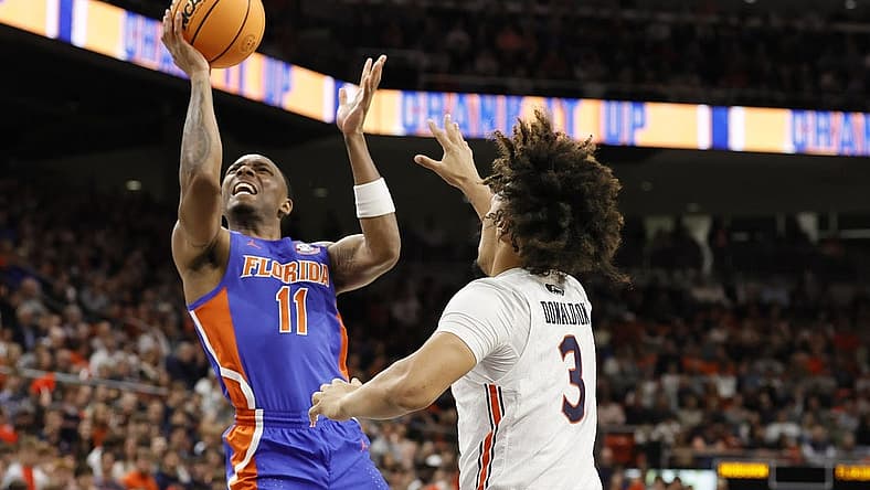 Dec 28, 2022; Auburn, Alabama, USA; Florida Gators guard Kyle Lofton (11) gets past Auburn Tigers guard Tre Donaldson (3) for a shot during the first half at Neville Arena. Mandatory Credit: John Reed-USA TODAY Sports