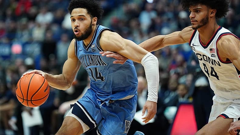 Dec 28, 2022; Hartford, Connecticut, USA; Villanova Wildcats guard Caleb Daniels (14) drives the ball against Connecticut Huskies guard Andre Jackson Jr. (44) during the second half at XL Center. Mandatory Credit: David Butler II-USA TODAY Sports