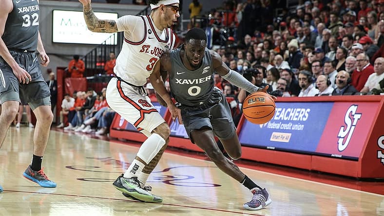 Dec 28, 2022; Queens, New York, USA;  Xavier Musketeers guard Souley Boum (0) drives past St. John's Red Storm guard Andre Curbelo (3) in the first half at Carnesecca Arena. Mandatory Credit: Wendell Cruz-USA TODAY Sports