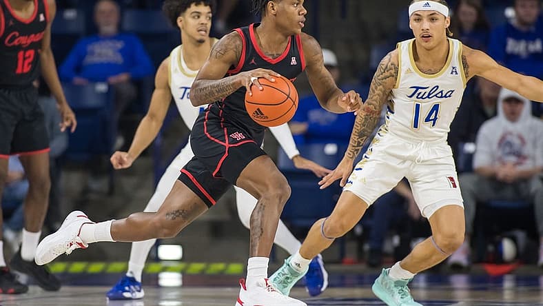 Dec 28, 2022; Tulsa, Oklahoma, USA; Houston Cougars guard Marcus Sasser (0) dribbles past Tulsa Golden Hurricane guard Anthony Pritchard (14) during the first half at Reynolds Center. Mandatory Credit: Brett Rojo-USA TODAY Sports