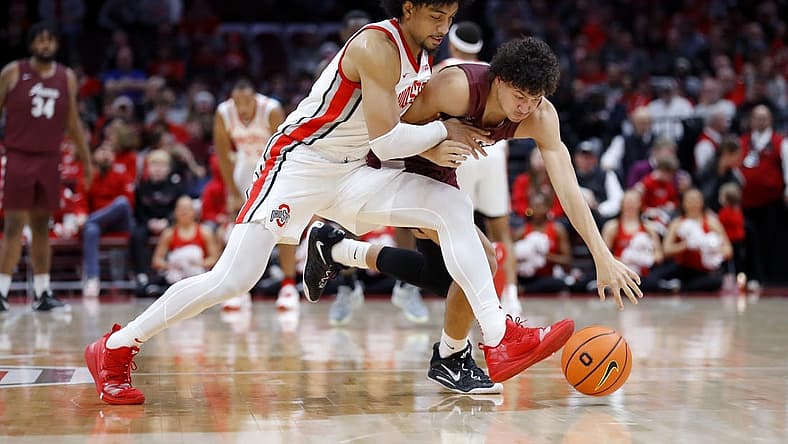 Dec 29, 2022; Columbus, Ohio, USA; Alabama A&M Bulldogs guard Eric Lee (right) fights for the loose ball with Ohio State Buckeyes forward Justice Sueing (14) during the first half at Value City Arena. Mandatory Credit: Joseph Maiorana-USA TODAY Sports