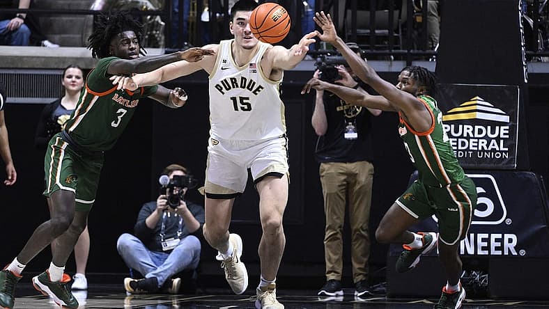 Dec 29, 2022; West Lafayette, Indiana, USA; Purdue Boilermakers center Zach Edey (15) reaches for a rebound between Florida A&M Rattlers forward Peyton Williams (3) and Florida A&M Rattlers guard Jordan Tillmon (23) during the first half at Mackey Arena. Mandatory Credit: Marc Lebryk-USA TODAY Sports