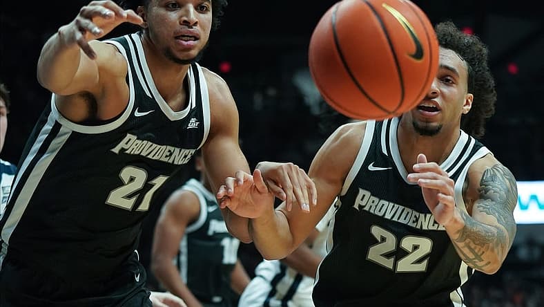 Dec 29, 2022; Indianapolis, Indiana, USA; Providence Friars forward Clifton Moore (21) and guard Devin Carter (22) chase after a loose ball against the Butler Bulldogs during the first half at Hinkle Fieldhouse. Mandatory Credit: Robert Goddin-USA TODAY Sports