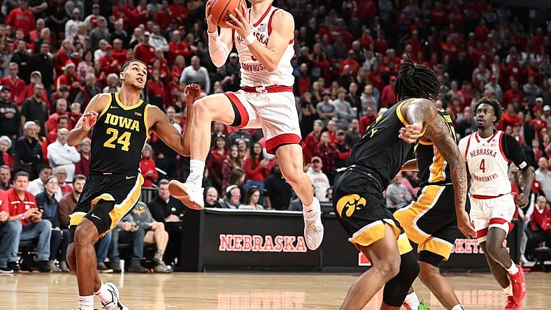 Dec 29, 2022; Lincoln, Nebraska, USA; Nebraska Cornhuskers guard Sam Griesel (5) scores on a drive against Iowa Hawkeyes forward Kris Murray (24) in the first half at Pinnacle Bank Arena. Mandatory Credit: Steven Branscombe-USA TODAY Sports