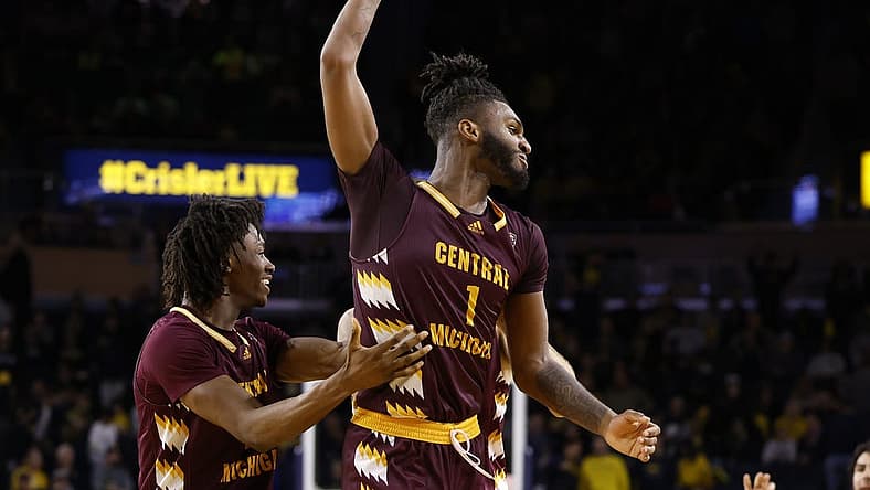 Dec 29, 2022; Ann Arbor, Michigan, USA; Central Michigan Chippewas forward Ola Ajiboye (11) and guard Reggie Bass (1) celebrate after defeating the Michigan Wolverines at Crisler Center. Mandatory Credit: Rick Osentoski-USA TODAY Sports