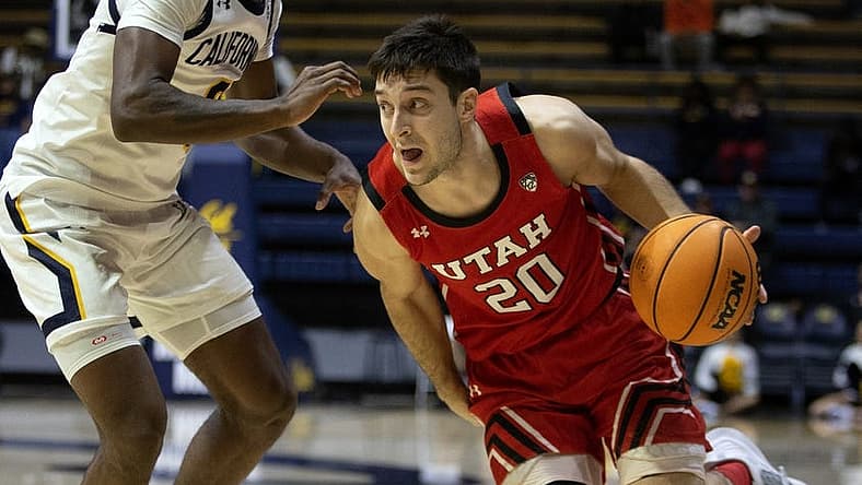 Dec 29, 2022; Berkeley, California, USA; Utah Utes guard Lazar Stefanovic (20) drives around California Golden Bears guard Marsalis Roberson (0) during the first half at Haas Pavilion. Mandatory Credit: D. Ross Cameron-USA TODAY Sports