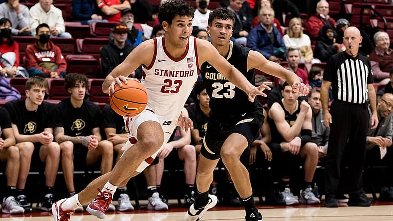 Dec 29, 2022; Stanford, California, USA; Stanford Cardinal forward Brandon Angel (23) drives past Colorado Buffaloes forward Tristan da Silva (23) during the first half at Maples Pavilion. Mandatory Credit: John Hefti-USA TODAY Sports