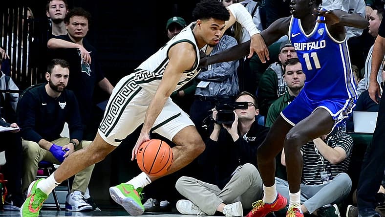 Dec 30, 2022; East Lansing, Michigan, USA; in his first game back from a foot injury Michigan State Spartans forward Malik Hall (25) drives against Buffalo Bulls forward Kuluel Mading (11) in the first half at Jack Breslin Student Events Center. Mandatory Credit: Dale Young-USA TODAY Sports