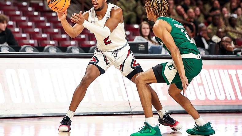 Dec 30, 2022; Columbia, South Carolina, USA; South Carolina Gamecocks guard Chico Carter Jr. (2) passes around Eastern Michigan Eagles guard Noah Farrakhan (2) in the first half at Colonial Life Arena. Mandatory Credit: Jeff Blake-USA TODAY Sports