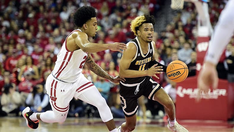 Dec 30, 2022; Madison, Wisconsin, USA; Western Michigan Broncos guard Lamar Norman Jr. (11) dribbles the ball under coverage by Wisconsin Badgers guard Chucky Hepburn (23) during the first half at the Kohl Center. Mandatory Credit: Kayla Wolf-USA TODAY Sports