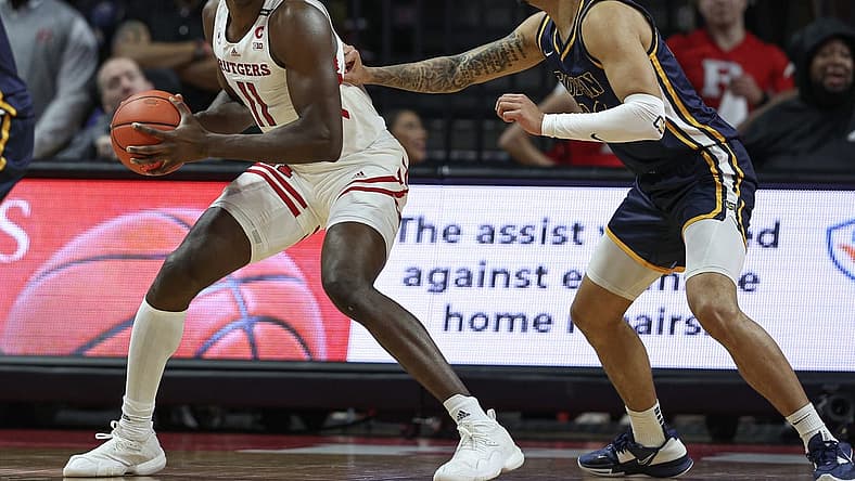 Dec 30, 2022; Piscataway, New Jersey, USA; Rutgers Scarlet Knights center Clifford Omoruyi (11) dribbles against Coppin State Eagles forward Luka Tekavcic (33) during the first half at Jersey Mike's Arena. Mandatory Credit: Vincent Carchietta-USA TODAY Sports