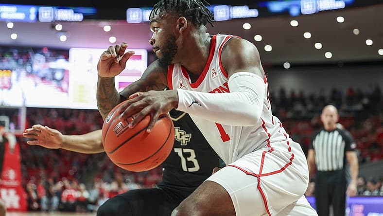 Dec 31, 2022; Houston, Texas, USA; Houston Cougars guard Jamal Shead (1) drives with the ball as Central Florida Knights guard C.J. Kelly (13) defends during the first half at Fertitta Center. Mandatory Credit: Troy Taormina-USA TODAY Sports