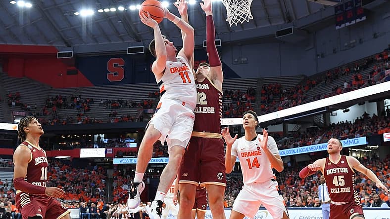 Dec 31, 2022; Syracuse, New York, USA; Syracuse Orange guard Joseph Girard III (11) shoots the ball as Boston College Eagles forward Quinten Post (12) defends during the first half at the JMA Wireless Dome. Mandatory Credit: Rich Barnes-USA TODAY Sports