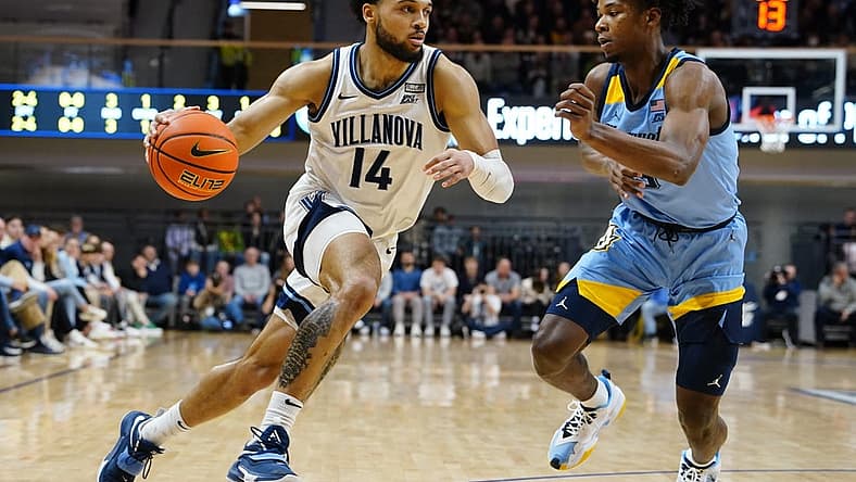 Dec 31, 2022; Villanova, Pennsylvania, USA; Villanova Wildcats guard Caleb Daniels (14) drives the ball against Marquette Golden Eagles guard Chase Ross (5) during the first half at William B. Finneran Pavilion. Mandatory Credit: Gregory Fisher-USA TODAY Sports