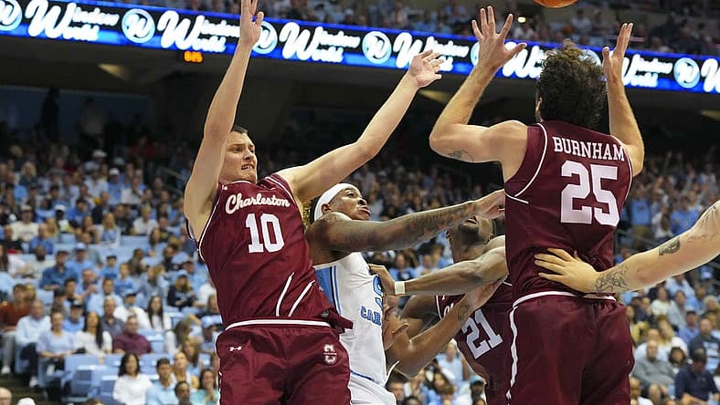 Nov 11, 2022; Chapel Hill, North Carolina, USA; North Carolina Tar Heels forward Armando Bacot (5) battles for the ball against Charleston Cougars forward Ante Brzovic (10) and forward Ben Burnham (25) during the second half at Dean E. Smith Center. Mandatory Credit: James Guillory-USA TODAY Sports