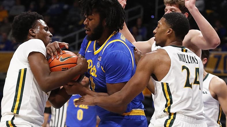 Nov 25, 2022; Pittsburgh, Pennsylvania, USA; William & Mary Tribe guard Gabe Dorsey (left) and Pittsburgh Panthers forward John Hugley IV (4) battle for the ball during the first half at Petersen Events Center. Mandatory Credit: Charles LeClaire-USA TODAY Sports