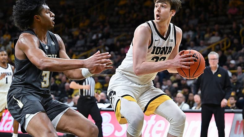 Nov 29, 2022; Iowa City, Iowa, USA; Iowa Hawkeyes forward Patrick McCaffery (22) is defended by Georgia Tech Yellow Jackets guard Dallan Coleman (3) during the second half at Carver-Hawkeye Arena. Mandatory Credit: Jeffrey Becker-USA TODAY Sports
