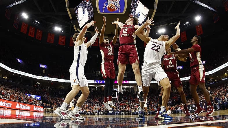 Dec 3, 2022; Charlottesville, Virginia, USA; Florida State Seminoles guard Cam'Ron Fletcher (21) and Seminoles guard Tom House (12) battle for a rebound with Virginia Cavaliers forward Ben Vander Plas (5) and Cavaliers center Francisco Caffaro (22) in the first half at John Paul Jones Arena. Mandatory Credit: Geoff Burke-USA TODAY Sports