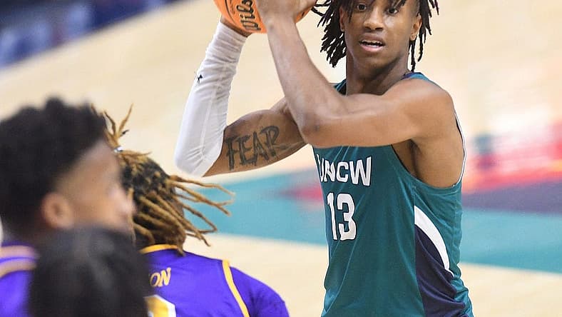 UNCW's #13 Trazarien White passes the ball off as UNCW took on ECU on Tuesday Dec. 6, 2022 at Trask Coliseum in Wilmington, N.C. UNCW beat ECU 74-61.
Wlm Uncw Hoops Vs Ecu19