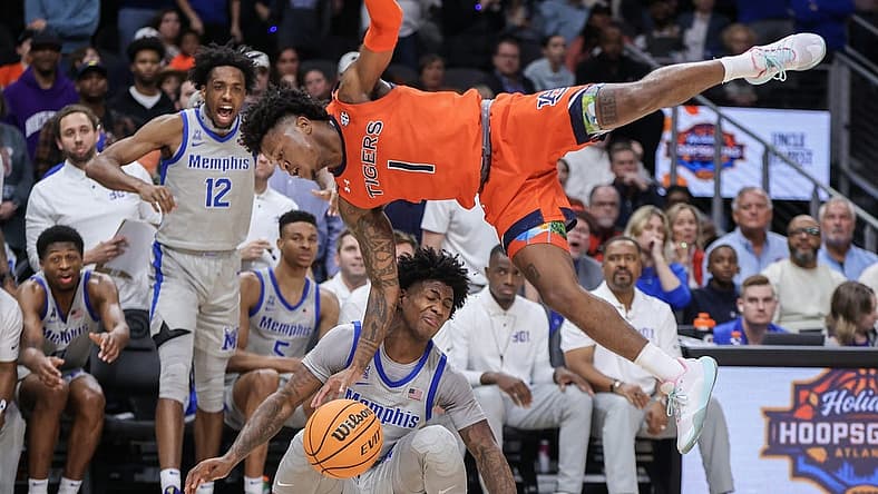 Dec 10, 2022; Atlanta, Georgia, USA; Auburn Tigers guard Wendell Green Jr. (1) dives over Memphis Tigers guard Kendric Davis (3) in the second half at State Farm Arena. Mandatory Credit: Brett Davis-USA TODAY Sports