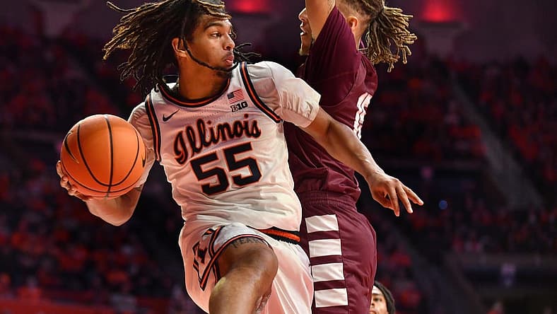 Dec 17, 2022; Champaign, Illinois, USA;  Illinois Fighting Illini guard Skyy Clark (55) drives the ball against Alabama A&M Bulldogs guard Dailin Smith (15) during the first half at State Farm Center. Mandatory Credit: Ron Johnson-USA TODAY Sports