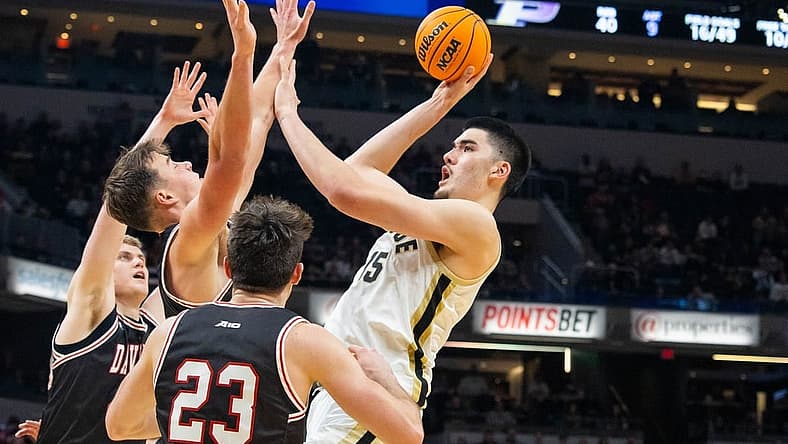 Dec 17, 2022; Indianapolis, Indiana, USA; Purdue Boilermakers center Zach Edey (15) shoots the ball against Davidson Wildcats forward Sam Mennenga (3) in the second half at Gainbridge Fieldhouse. Mandatory Credit: Trevor Ruszkowski-USA TODAY Sports