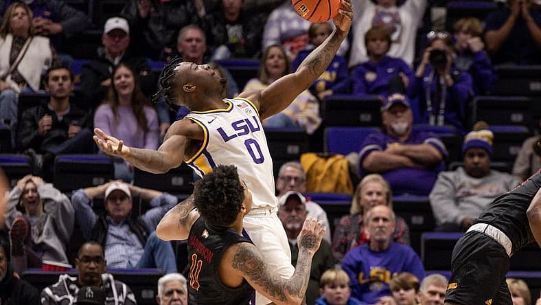 Dec 17, 2022; Baton Rouge, Louisiana, USA; LSU Tigers guard Trae Hannibal (0) grabs a rebound against Winthrop Eagles guard Kasen Harrison (11) during the second half at Pete Maravich Assembly Center. Mandatory Credit: Stephen Lew-USA TODAY Sports