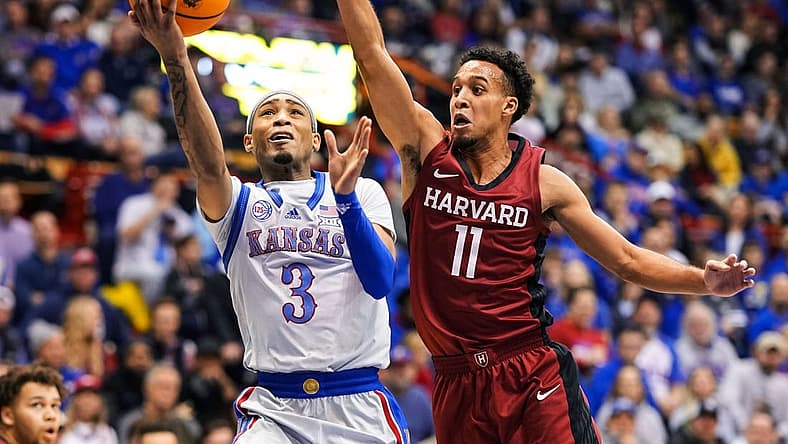 Dec 22, 2022; Lawrence, Kansas, USA; Kansas Jayhawks guard Dajuan Harris Jr. (3) shoots against Harvard Crimson guard Evan Nelson (11) during the second half at Allen Fieldhouse. Mandatory Credit: Jay Biggerstaff-USA TODAY Sports