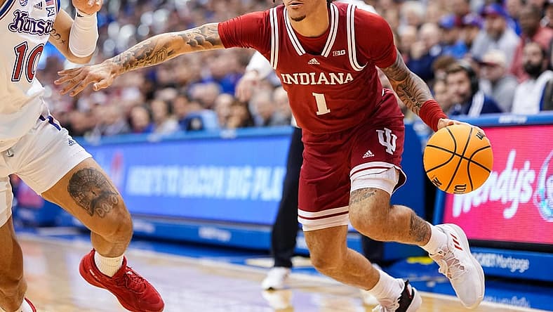 Dec 17, 2022; Lawrence, Kansas, USA; Indiana Hoosiers guard Jalen Hood-Schifino (1) drives against Kansas Jayhawks forward Jalen Wilson (10) during the first half at Allen Fieldhouse. Mandatory Credit: Jay Biggerstaff-USA TODAY Sports