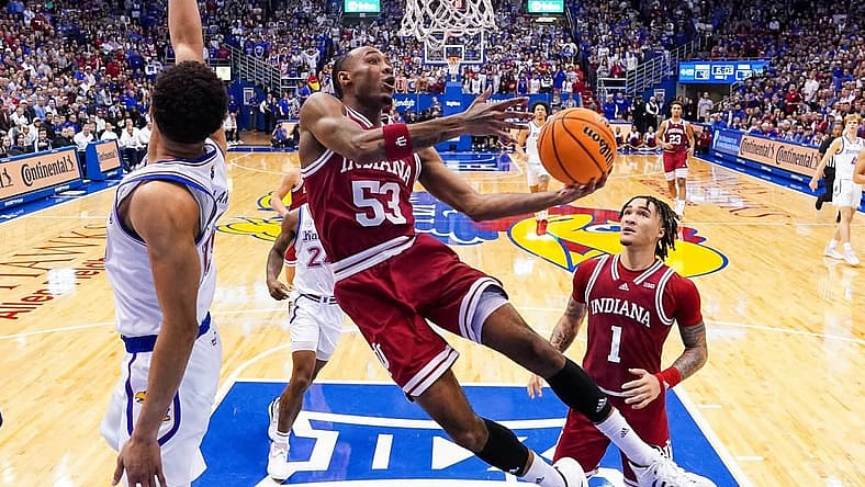 Dec 17, 2022; Lawrence, Kansas, USA; Indiana Hoosiers guard Tamar Bates (53) shoots against Kansas Jayhawks guard Kevin McCullar Jr. (15) during the second half at Allen Fieldhouse. Mandatory Credit: Jay Biggerstaff-USA TODAY Sports