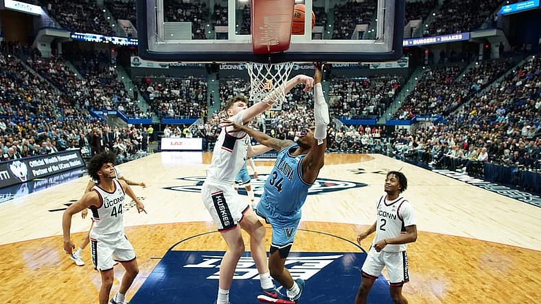 Dec 28, 2022; Hartford, Connecticut, USA; Connecticut Huskies center Donovan Clingan (32) defends against Villanova Wildcats forward Brandon Slater (34) during the first half at XL Center. Mandatory Credit: David Butler II-USA TODAY Sports